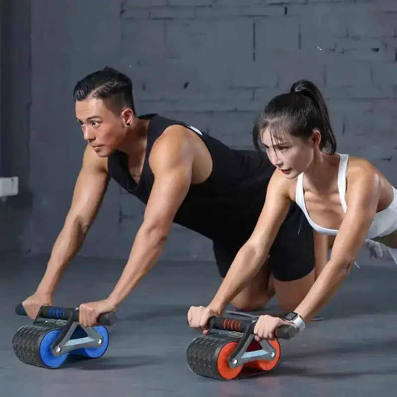 Man and woman using ab rollers for core workout in gym